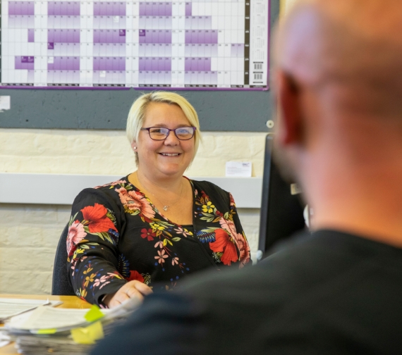A female is reading a ring binder of information